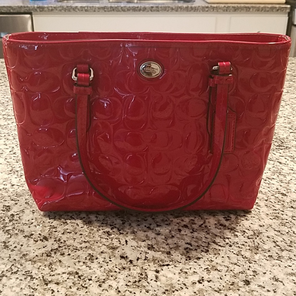 Never been used trendy Coach Brand red hand bag.